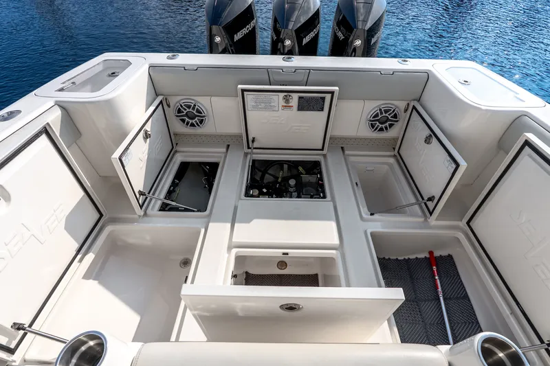 Slide: The Image of 2023 SeaVee 370Z boat deck with open storage compartments and Mercury engines. - 61