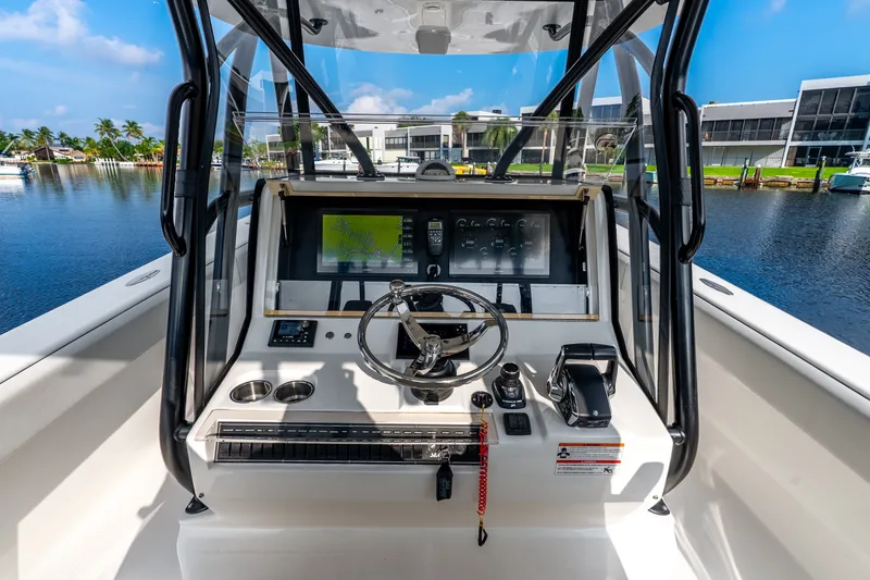 Slide: The Image of 2023 SeaVee 370Z boat cockpit with steering wheel and navigation display. - 46