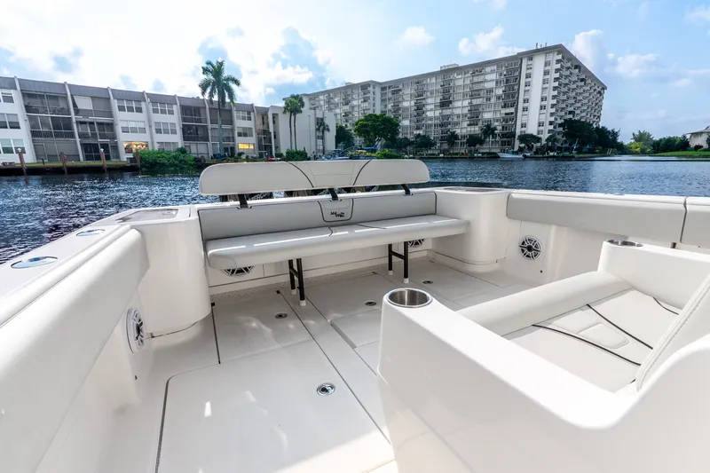 Slide: The Image of 2023 SeaVee 370Z boat interior with seating, overlooking waterfront buildings. - 49