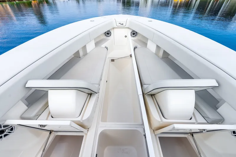 Slide: The Image of 2023 SeaVee 370Z boat interior with white seating and storage compartments. - 39