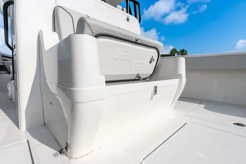 Slide: The Image of 2023 SeaVee 370Z boat deck with storage compartment under clear blue sky. - 65