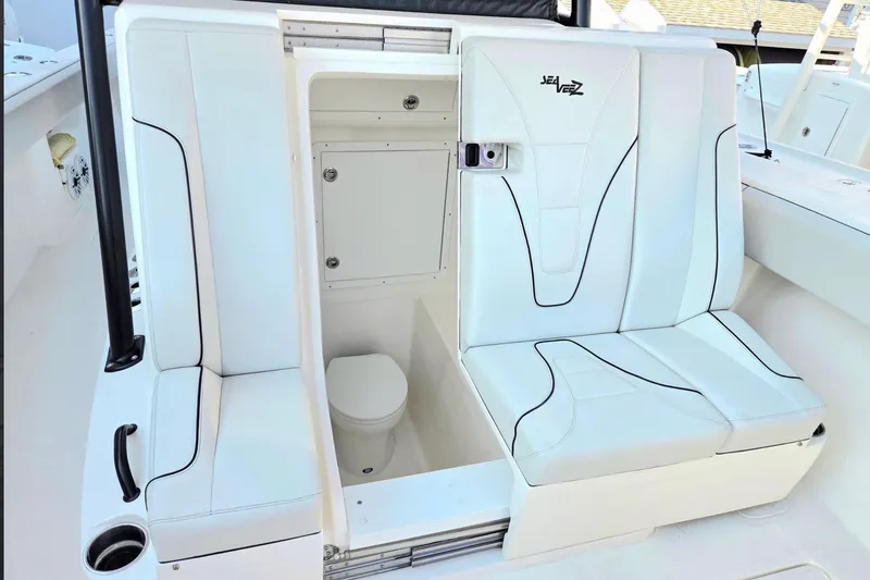 Slide: The Image of 2023 SeaVee 370Z boat interior with white seating and hidden toilet compartment. - 5