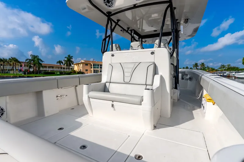 Slide: The Image of 2023 SeaVee 370Z boat interior with sleek seating and modern design under a clear blue sky. - 56