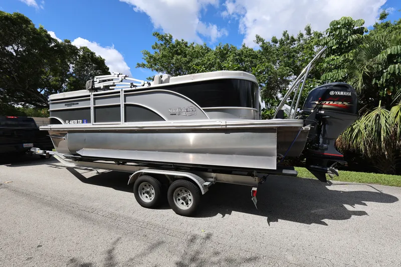 Slide: The Image of 2023 SunCatcher Select 320 RC pontoon boat on trailer, parked outdoors. - 4