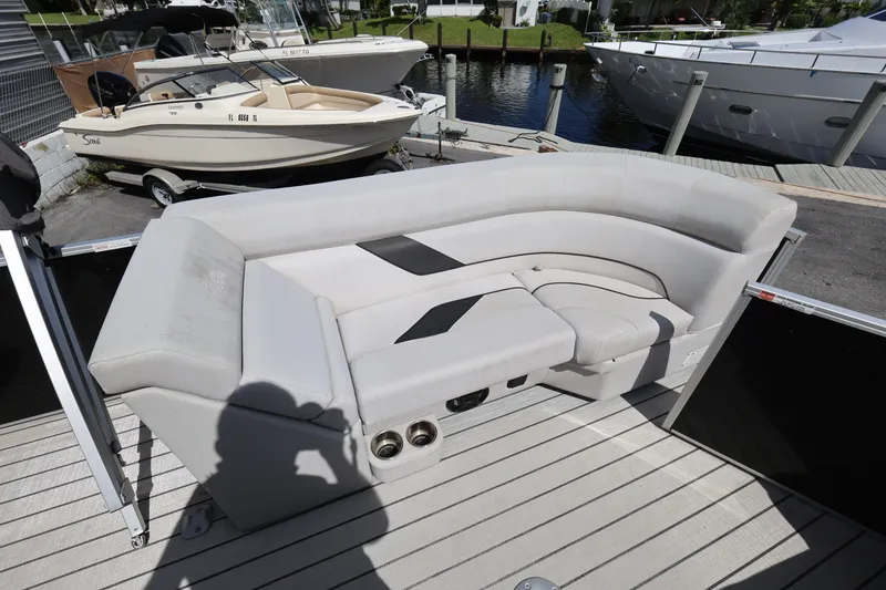 Slide: The Image of 2023 SunCatcher Select 320 RC boat interior with plush seating and cup holders. - 10