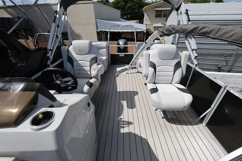 Slide: The Image of 2023 SunCatcher Select 320 RC pontoon boat interior with plush seating and modern helm. - 11