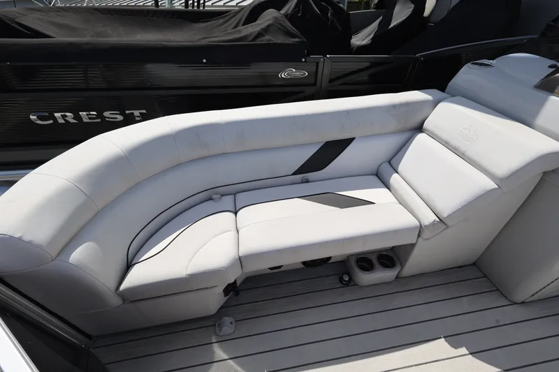 Slide: The Image of 2023 SunCatcher Select 320 RC boat interior with white cushioned seating. - 9