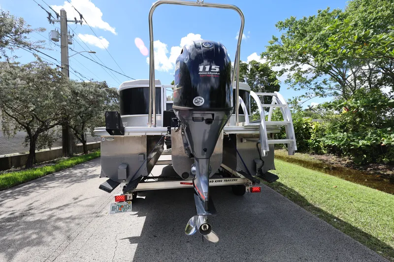 Slide: The Image of 2023 SunCatcher Select 320 RC boat on trailer, featuring a 115 horsepower outboard motor. - 5