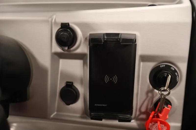 Slide: The Image of 2023 South Bay S222RS dashboard with ignition key and wireless charging pad. - 24
