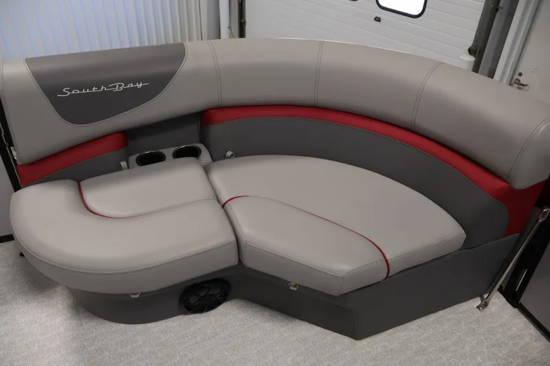 Slide: The Image of 2023 South Bay S222RS boat seating with gray and red upholstery, featuring cup holders. - 10