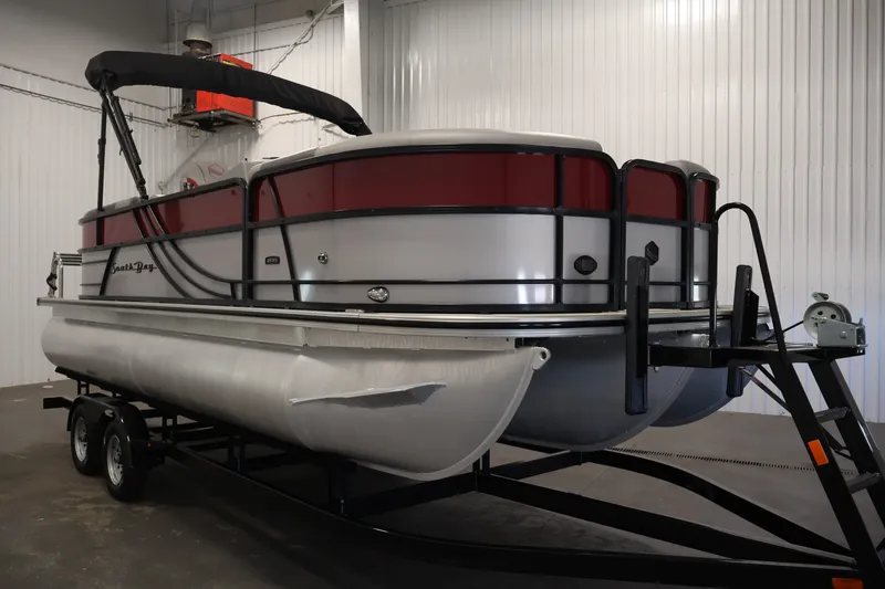 Slide: The Image of 2023 South Bay S222RS pontoon boat on trailer in indoor storage. - 3