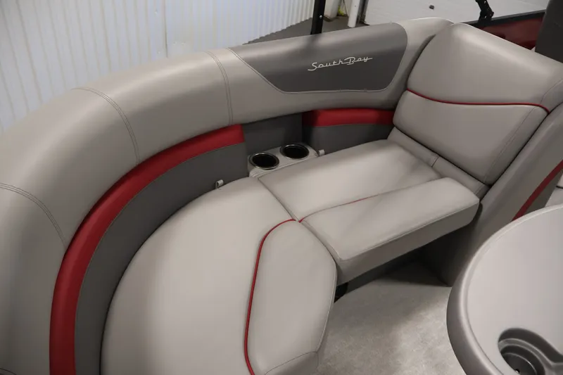 Slide: The Image of 2023 South Bay S222RS pontoon boat interior with gray and red cushioned seating. - 29