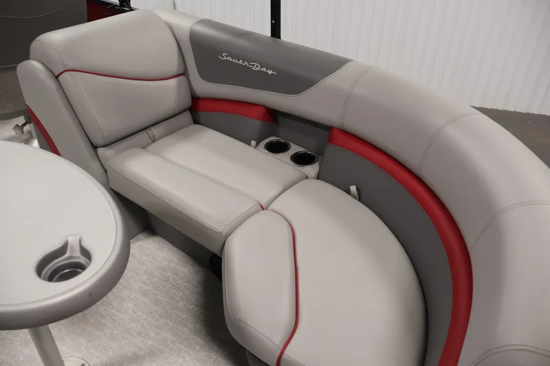 Slide: The Image of 2023 South Bay S222RS boat interior with gray and red seating, featuring cup holders. - 31