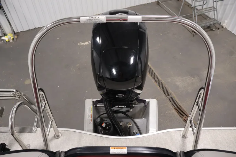 Slide: The Image of 2023 South Bay S222RS boat engine with safety railing in a garage setting. - 33