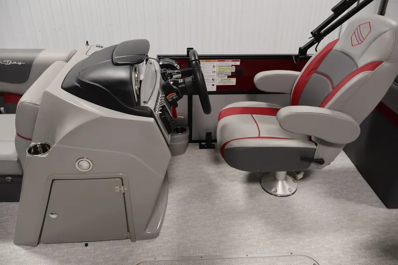 Slide: The Image of 2023 South Bay S222RS boat interior with captain's chair and control console. - 14