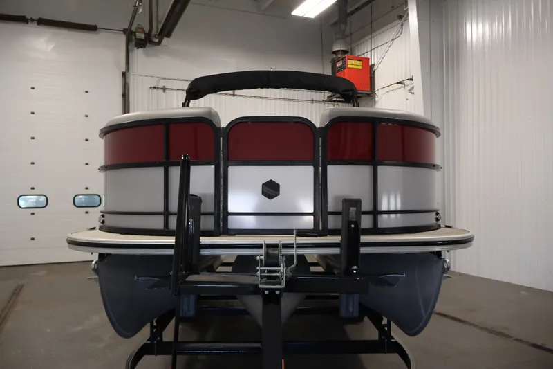 Slide: The Image of 2023 South Bay S222RS pontoon boat in a garage, front view. - 2