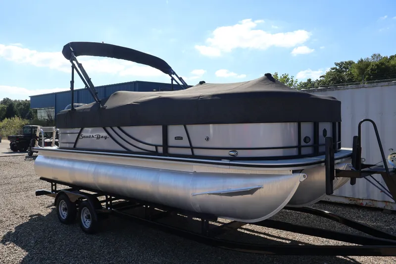 Slide: The Image of 2023 South Bay S222RS pontoon boat on trailer, covered and parked outdoors. - 42
