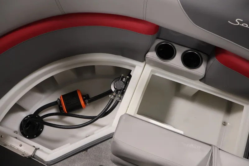 Slide: The Image of 2023 South Bay S222RS boat interior storage compartment with cup holders and pump system. - 30