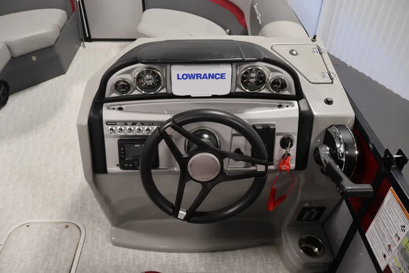 Slide: The Image of 2023 South Bay S222RS boat dashboard with steering wheel and Lowrance display. - 16