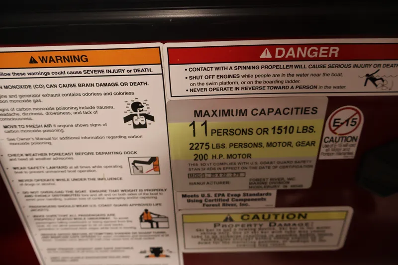 Slide: The Image of Warning and capacity labels on 2023 South Bay S222RS boat, highlighting safety and weight limits. - 25
