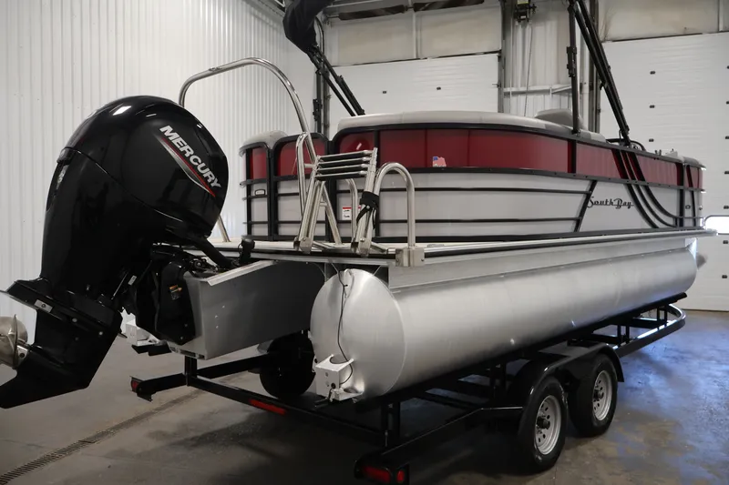 Slide: The Image of 2023 South Bay S222RS pontoon boat with Mercury outboard motor in a garage. - 5