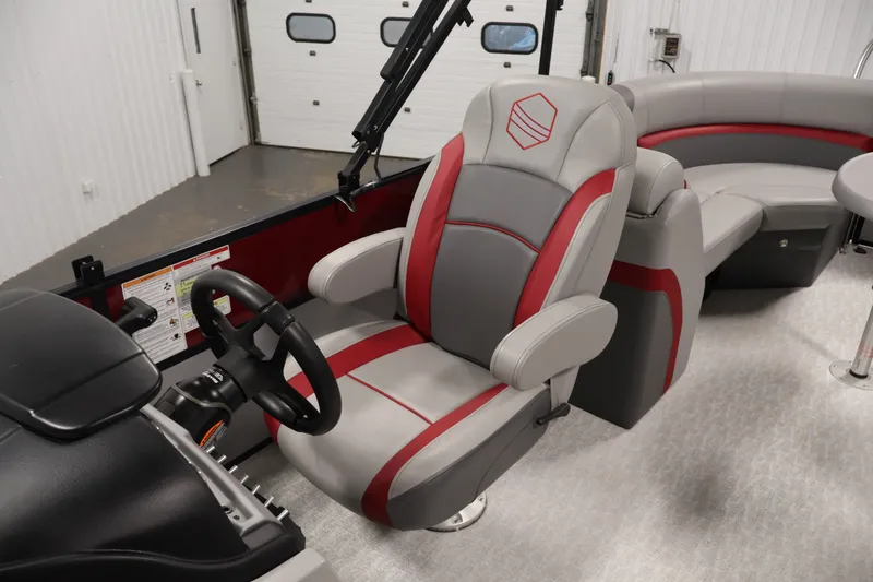 Slide: The Image of 2023 South Bay S222RS boat interior with red and gray captain's chair and steering wheel. - 26