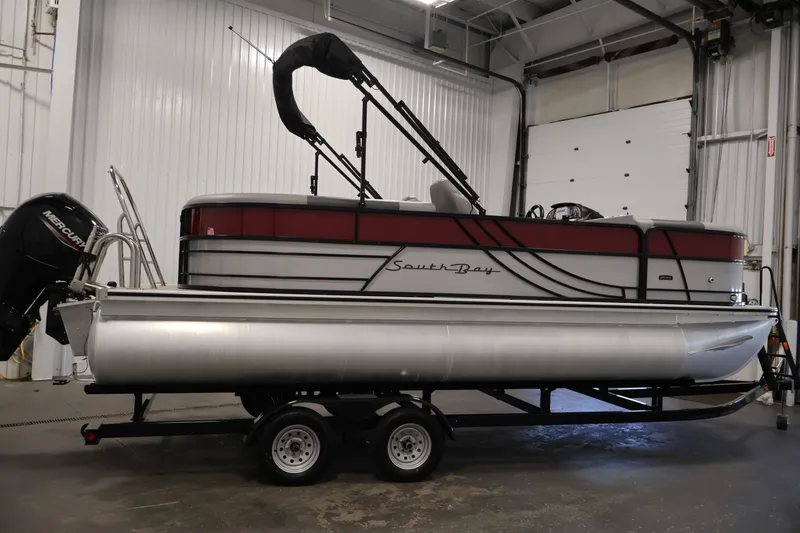 Slide: The Image of 2023 South Bay S222RS pontoon boat on trailer in indoor storage. - 4