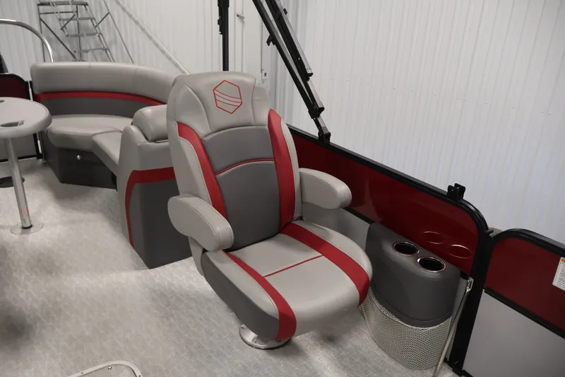 Slide: The Image of 2023 South Bay S222RS pontoon boat interior with gray and red seating and cup holders. - 27