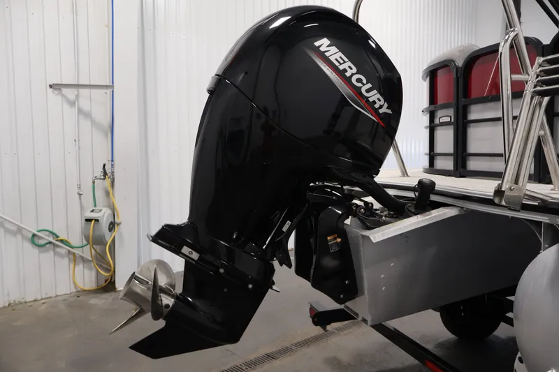 Slide: The Image of 2023 South Bay S222RS boat with Mercury outboard motor in a garage setting. - 34