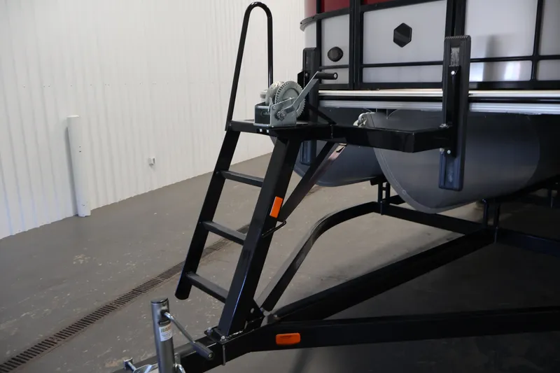 Slide: The Image of 2023 South Bay S222RS pontoon boat trailer with ladder and winch in a garage. - 37