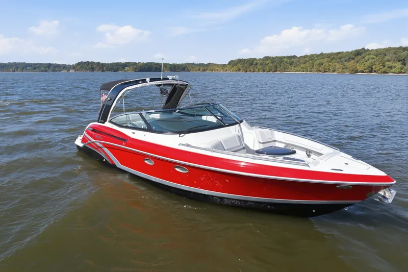 Slide: The Image of 2016 Formula 330 Crossover Bowrider in red, cruising on a scenic lake. - 4