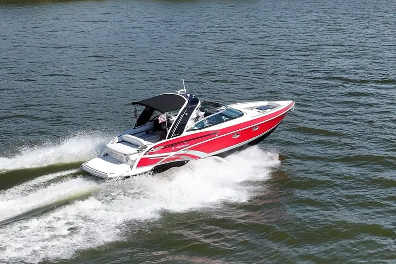 Slide: The Image of 2016 Formula 330 Crossover Bowrider cruising on open water, creating a wake. - 19