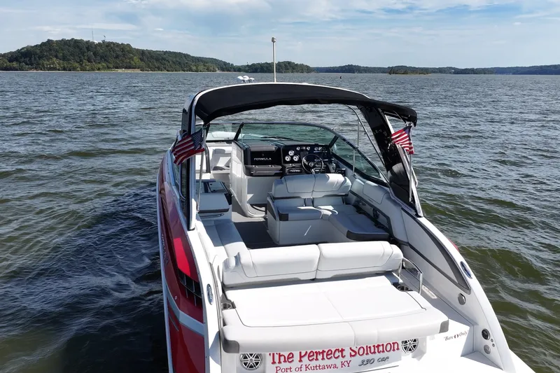 Slide: The Image of 2016 Formula 330 Crossover Bowrider on a scenic lake with lush green shoreline. - 13
