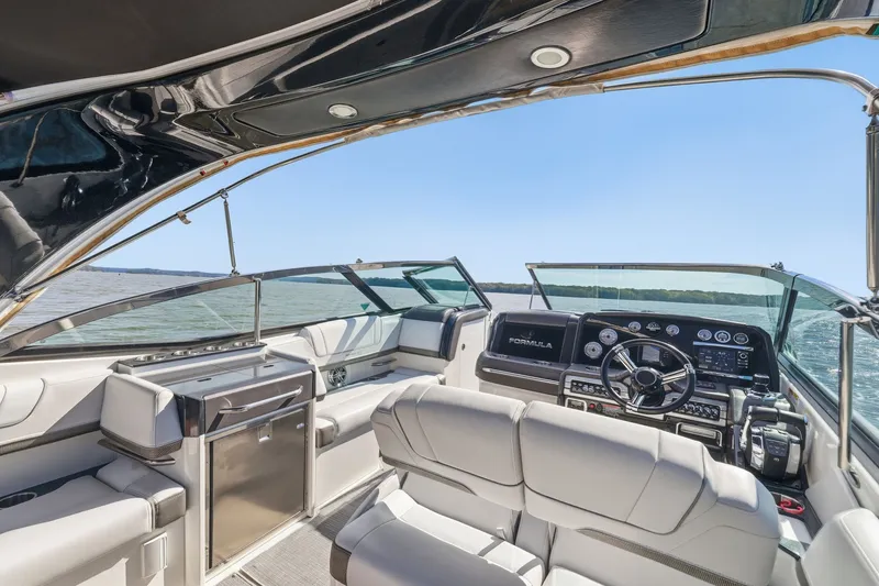 Slide: The Image of 2016 Formula 330 Crossover Bowrider interior with luxurious seating and modern dashboard on open water. - 39