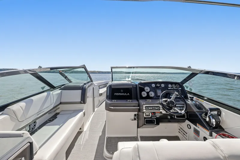 Slide: The Image of 2016 Formula 330 Crossover Bowrider interior with steering console, on open water. - 35