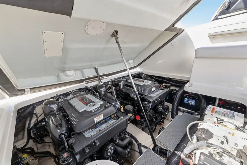 Slide: The Image of Engine compartment of a 2016 Formula 330 Crossover Bowrider, showcasing dual engines. - 57