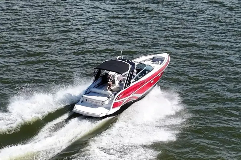 Slide: The Image of 2016 Formula 330 Crossover Bowrider cruising on open water, showcasing sleek design and performance. - 20