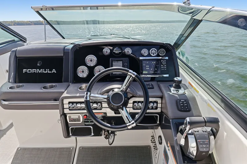Slide: The Image of Helm of 2016 Formula 330 Crossover Bowrider with modern controls and gauges on open water. - 32