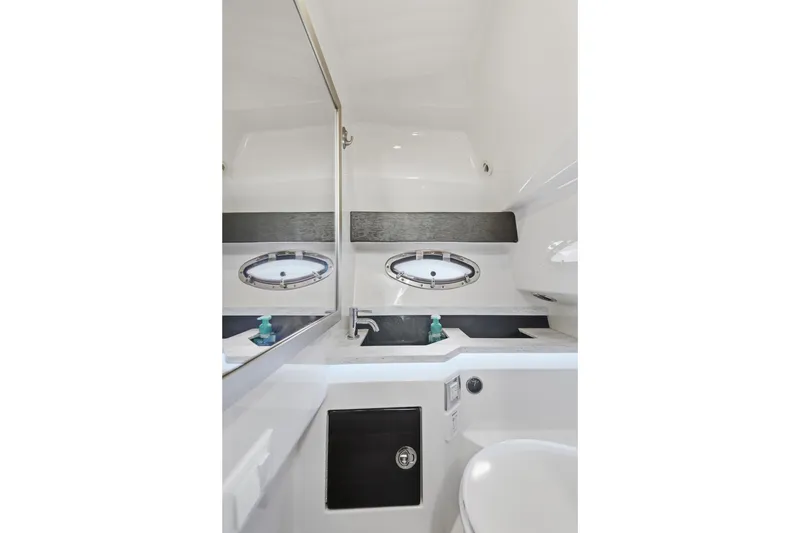 Slide: The Image of Interior of 2016 Formula 330 Crossover Bowrider bathroom with sink and porthole window. - 51
