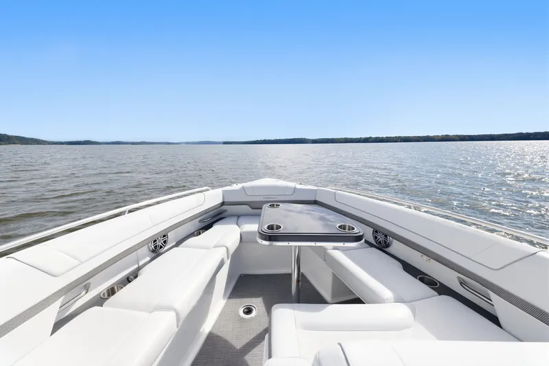 Slide: The Image of 2016 Formula 330 Crossover Bowrider interior with seating and table on open water. - 23