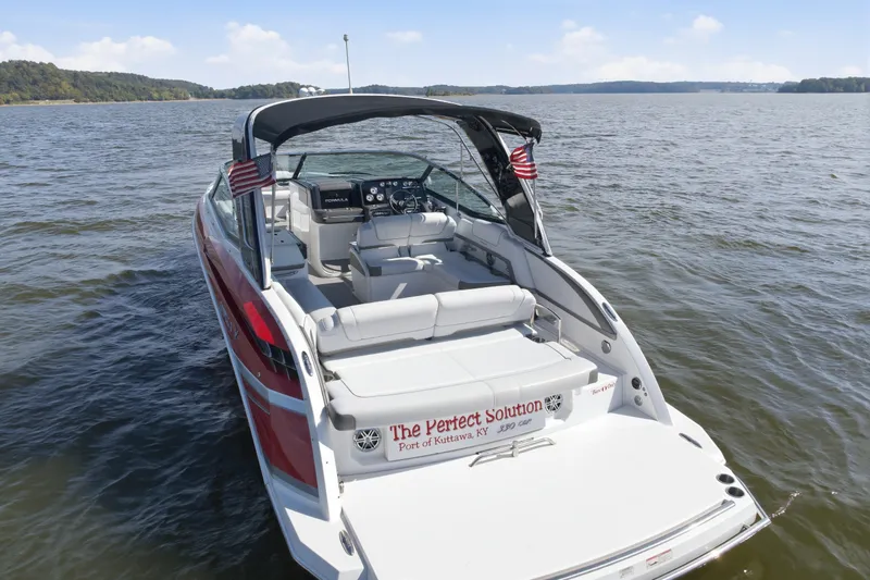 Slide: The Image of 2016 Formula 330 Crossover Bowrider on water, rear view with American flags. - 10