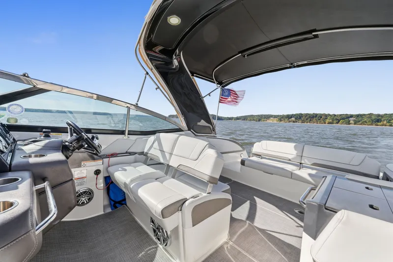 Slide: The Image of 2016 Formula 330 Crossover Bowrider interior with seating, steering wheel, and lake view. - 42