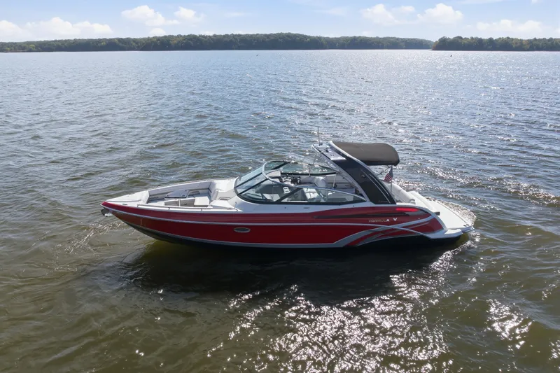 Slide: The Image of 2016 Formula 330 Crossover Bowrider on a sunny lake, showcasing sleek design and vibrant colors. - 6