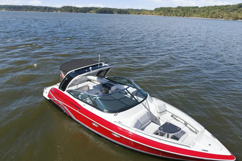Slide: The Image of 2016 Formula 330 Crossover Bowrider cruising on a scenic lake. - 8