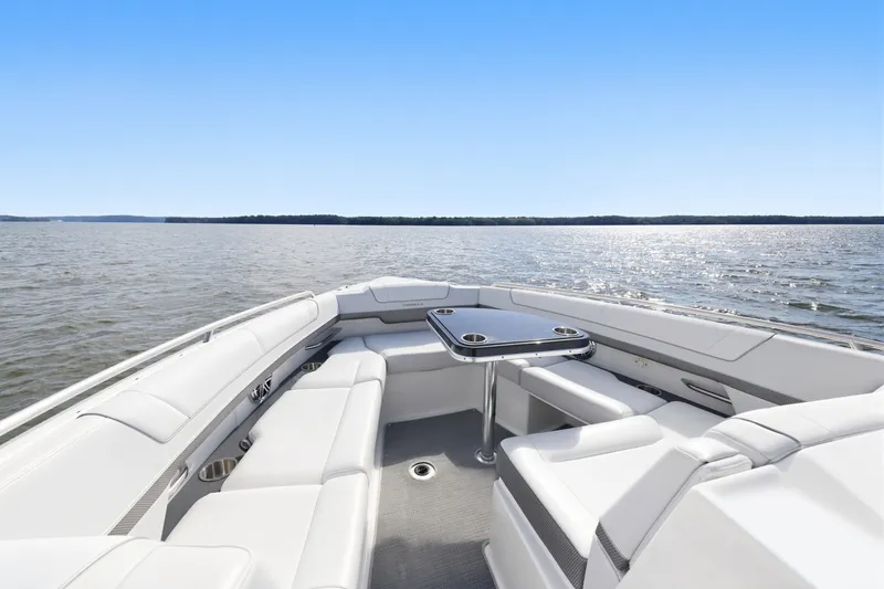 Slide: The Image of 2016 Formula 330 Crossover Bowrider on serene water, featuring spacious seating and sleek design. - 22