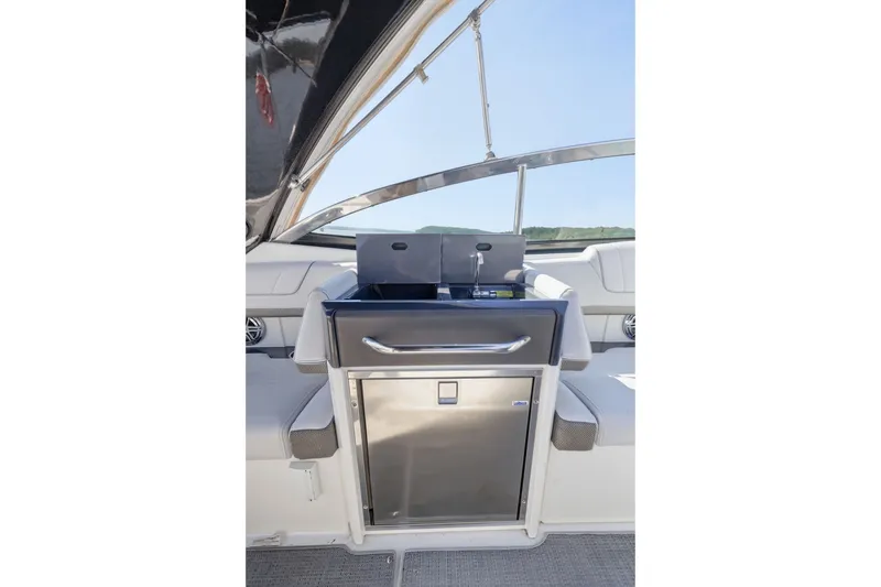 Slide: The Image of 2016 Formula 330 Crossover Bowrider interior with stainless steel kitchenette and seating. - 45