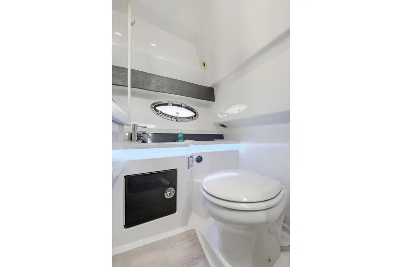 Slide: The Image of 2016 Formula 330 Crossover Bowrider bathroom with modern fixtures and porthole window. - 50