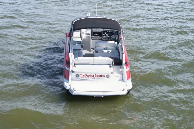 Slide: The Image of 2016 Formula 330 Crossover Bowrider on water, rear view, with seating and dashboard visible. - 7
