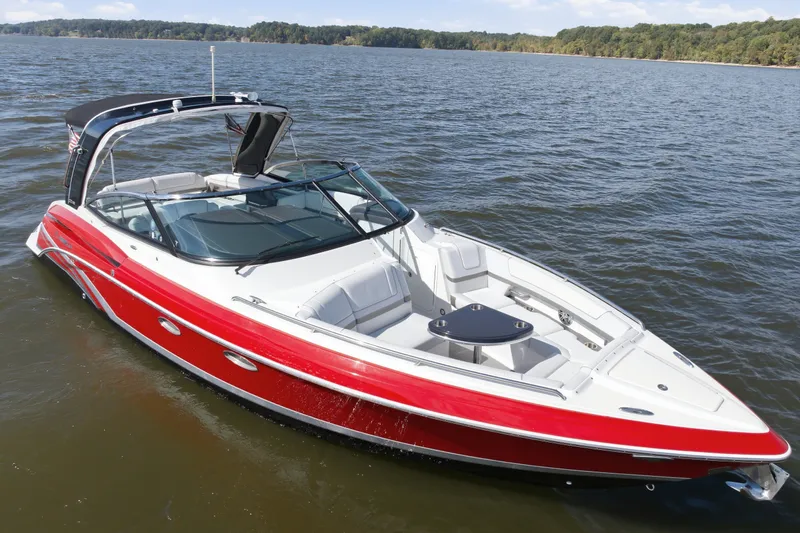 Slide: The Image of 2016 Formula 330 Crossover Bowrider in vibrant red on a serene lake. - 9