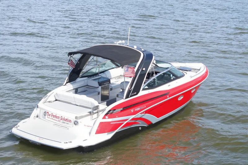 Slide: The Image of 2016 Formula 330 Crossover Bowrider, red and white, cruising on open water. - 1